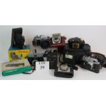 A collection of vintage cameras and cases including a Canon AE1 Zorki-4, Kodak Brownies etc, plus