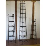 Three vintage wrought iron kitchen pot/saucepan stands of triangular form. Tallest 184cm. (3).