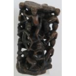 A decorative Ethnic African hardwood carving depicting multiple figures in various poses. Height: