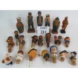 A collection of mainly Black Forest style carved wood figures and bottle stoppers including
