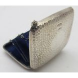 A small silver hammered purse with blue silk lining, Birmingham 1909. Condition report: Some