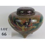 A three footed Chinese porcelain covered censer jar with dragon decoration and pierced lid. Seal