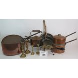 Various copper and brass ware including candlesticks, a huge 19th Century sauce pans, trio of frying