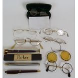 Six pairs of vintage gold filled spectacles including one pair of clip on sunglasses plus three pens