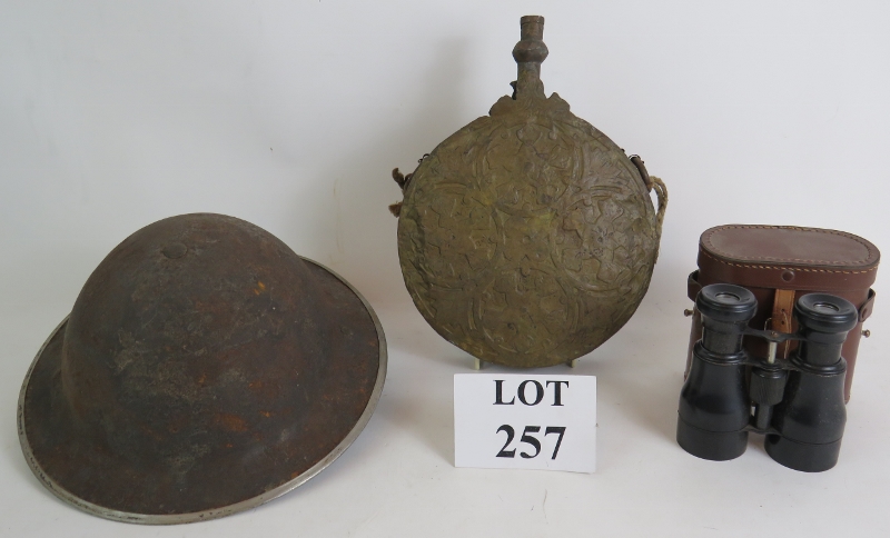 A WW2 steel helmet stamped 1939, a large brass Ottoman powder or water flask and a pair of
