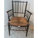 A 19th century ebonised and rush seated Sussex armchair by William Morris, in original unrestored