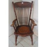 A turn of the century oak fireside Windsor chair with ornate carved back splat & spurtle turned