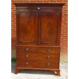 A Georgian mahogany linen press with parquetry inlaid cornice over a two double doors opening onto