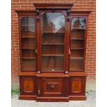 A Victorian mahogany breakfront library bookcase, the cornice featuring carved corbels, over three