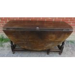 A substantial early 18th century oak oval gateleg table with single drawer to one side raised on