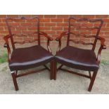 A pair of good quality reproduction mahogany open sided armchairs by Chelsea House, with carved &