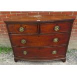 A Georgian mahogany bow fronted chest of two short over two long cock beaded drawers fitted with