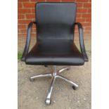 A contemporary Italian height adjustable swivel desk chair by Frag, upholstered in supple black