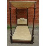 A Victorian mahogany four poster single bed with carved & fluted uprights. 206cm high x 116cm wide x