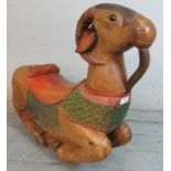 A hardwood carved & painted 'rocking goat'. 65cm high x 78cm wide x 20cm deep (approx) Estimated: £