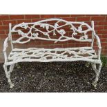 A 19th century white painted cast iron garden bench in the manner of Coalbrookdale, depicting branch