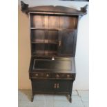 A late 19th/early 20th century Arts & Crafts ebonised Liberty style oak bureau bookcase with