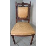 A vintage French oak occasional chair, the pierced cornice carved with swags & bows, with turned