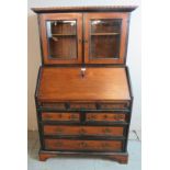 An 18th century Georgian mahogany ebonised bureau bookcase with dentil cornice over glazed doors