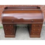 A large late Victorian mahogany cylindrical desk, the fitted interior housing an array of