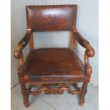 A 19th century Dutch mahogany framed open sided armchair upholstered in the original deeply