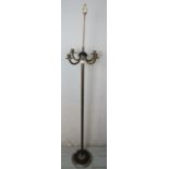 A 19th century brass floor standing four branch candelabra, with a fluted column terminating on a