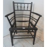 A 19th century ebonised Sussex armchair in the manner of William Morris, in need of re-caning.