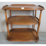 A mid century Ercol Windsor three tier butler's/drinks trolley in elm, raised on castors. 78cm