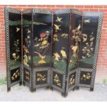 A vintage Japanese seven section folding screen, ornately decorated with mother of pearl inlay and
