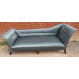 A large chaise longue upholstered in blue & silver contemporary material, raised on out swept