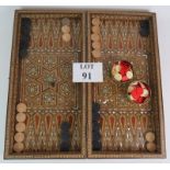 An inlaid Damascus Ware games box with backgammon board interior and chess board exterior. Bone