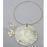 Handmade silver pendant & necklace, London 2012, and a pair of silver earrings. Estimated: £140-£160