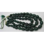 A heavy natural earth mined dark green semi precious three strand stone necklace. Each stone with