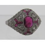 A platinum Victorian style ruby & diamond ring, the centre ruby approx 8mm x 6mm with fourteen small