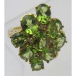 Peridot gemstone ring, overall setting 27 x 22 approx, oval brilliant cut stones, size S/T.