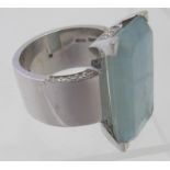 An 18ct white gold ring set with octagon Beryl-aquamarine weighing 13.24cts. 28mm x 16mm and 32