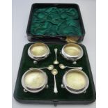 A set of four cauldron shaped silver salts on ball feet & gilded interiors, with four matching