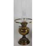 A brass based double wick oil lamp and another smaller oil lamp with copper base. (2). Tallest: