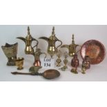 A selection of Eastern brass and copper wares including four Dallah coffee pots, four Kohl