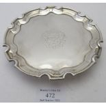 A Georgian silver salver on three hoof feet, pie crust edge and engraved central crest. Approx 6"