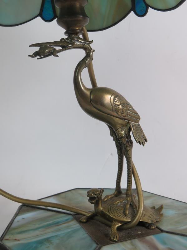 A decorative Chinese inspired stained glass lamp with support formed of a stork with a frog in its - Image 2 of 3