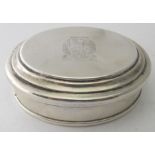 An oval modern silver trinket box engraved with crest and 'Probabit Gustus' on the lid. Engraving on