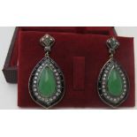 A pair of gold and silver drop earrings set with cabochon jade, onyx and diamonds. Earrings approx