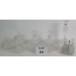 A four piece cut crystal dressing table set, three similar covered jars, a cut glass candlestick and