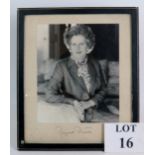 A signed black and white photograph of Margaret Thatcher MP mounted in a blue leather easel frame.
