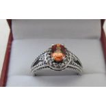 9ct white gold ring set with centre orange sapphire, approx 8mm x 5mm, size N, boxed. Condition