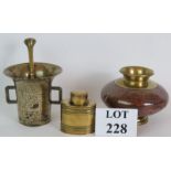 A heavy brass antique pestle and mortar, a squat brass and copper pot and a brass tea caddy.