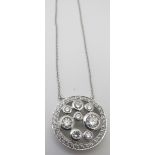 A fine diamond cluster slide pendant, probably 18ct white gold, on a fine platinum chain. The