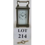 A brass cased 8 day carriage clock with enamel dial and bevelled glass glazing. Key present.