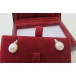 A pair of 9ct yellow & white gold oval cultured pearl and baguette cut diamond drop stud earrings,